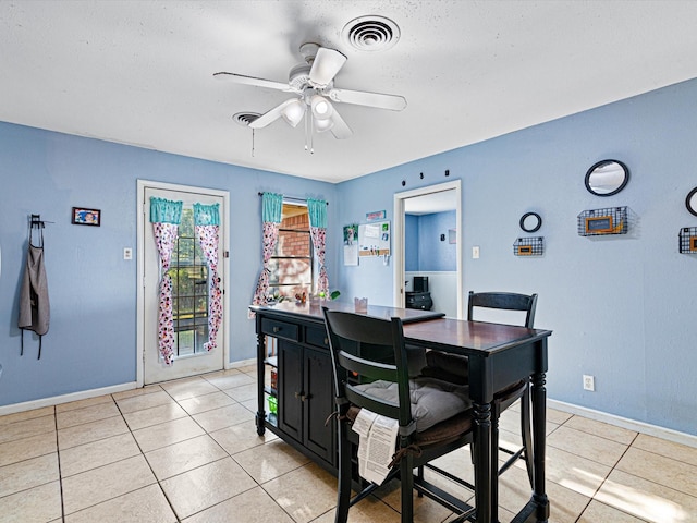 dining space with ceiling fan and light tile patterned floors