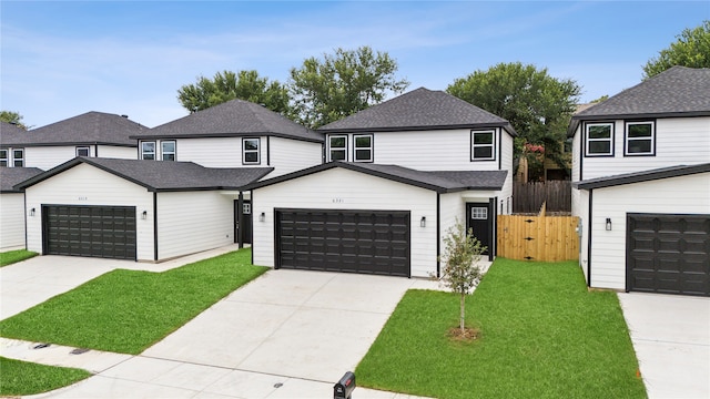 view of front of property with a garage and a front lawn