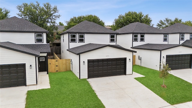 view of front property with a garage and a front lawn