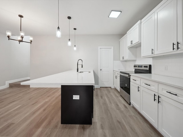 kitchen featuring sink, white cabinetry, pendant lighting, stainless steel electric stove, and a kitchen island with sink