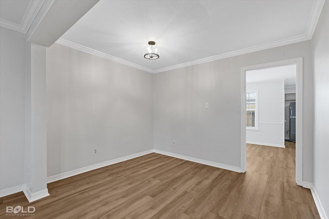 unfurnished room featuring hardwood / wood-style flooring and crown molding