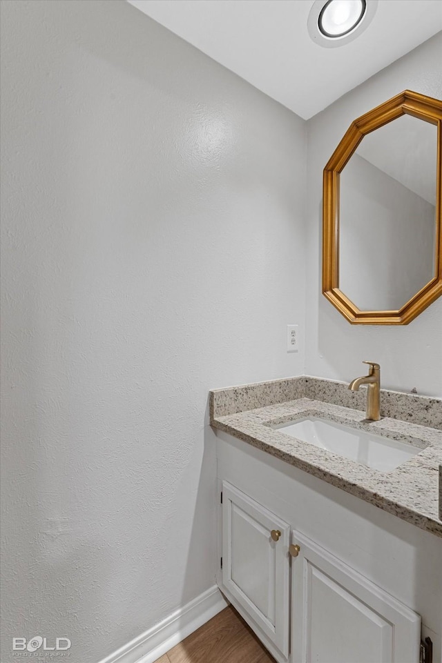 bathroom with vanity and hardwood / wood-style flooring