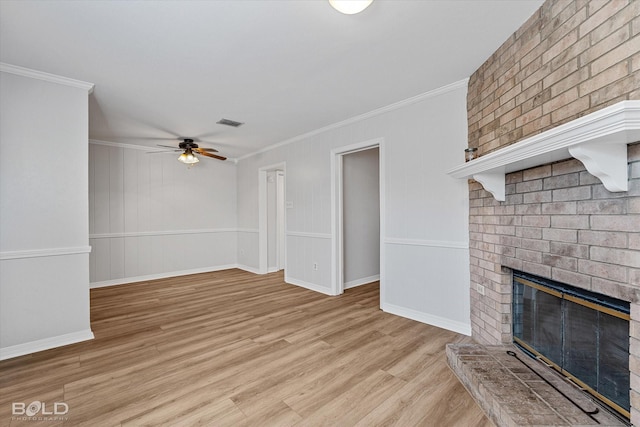 unfurnished living room featuring a fireplace, light hardwood / wood-style flooring, ceiling fan, and ornamental molding