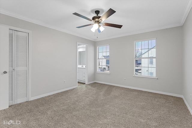 unfurnished bedroom featuring a closet, light colored carpet, ceiling fan, and ornamental molding