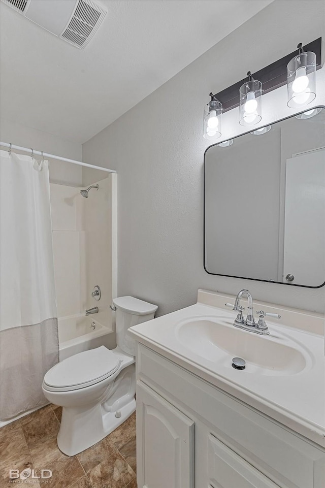 full bathroom with vanity, toilet, and shower / tub combo