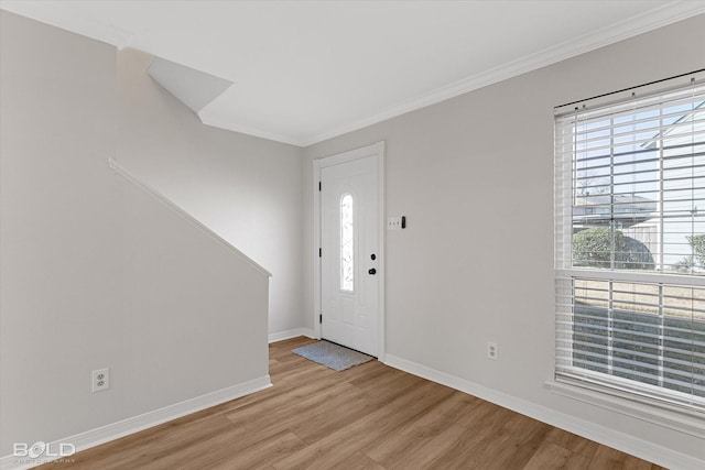 entrance foyer featuring light wood-type flooring and crown molding