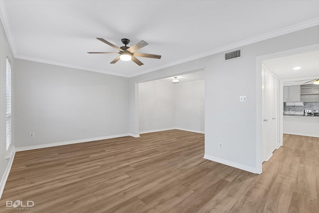 unfurnished room with ceiling fan, ornamental molding, and light hardwood / wood-style flooring