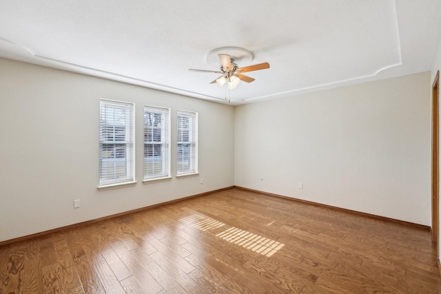 spare room with ceiling fan and light wood-type flooring