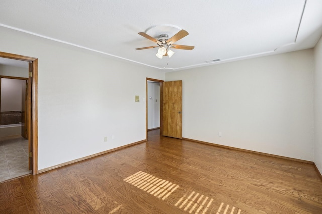 unfurnished room with hardwood / wood-style flooring and ceiling fan