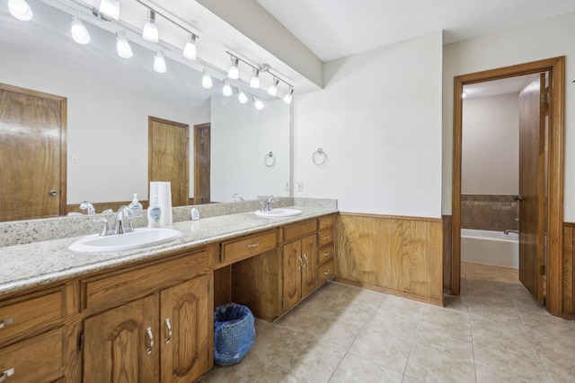 bathroom with tile patterned flooring, vanity, a bathtub, and wood walls