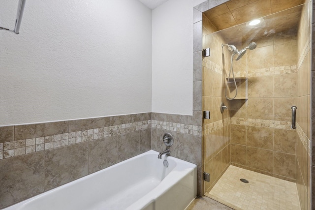 bathroom featuring separate shower and tub