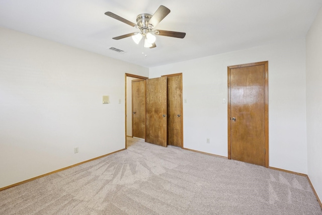 unfurnished bedroom with ceiling fan and light carpet