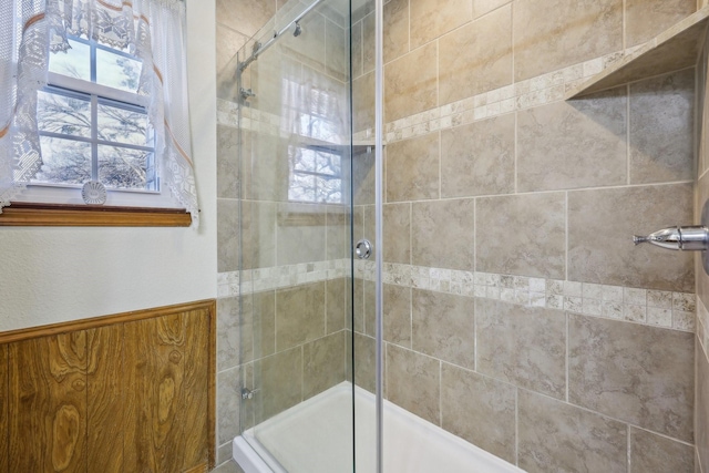 bathroom with walk in shower and wooden walls