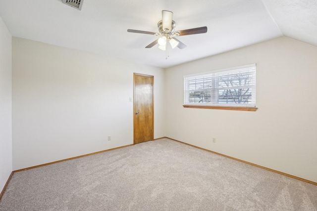 unfurnished room with carpet flooring, ceiling fan, and vaulted ceiling