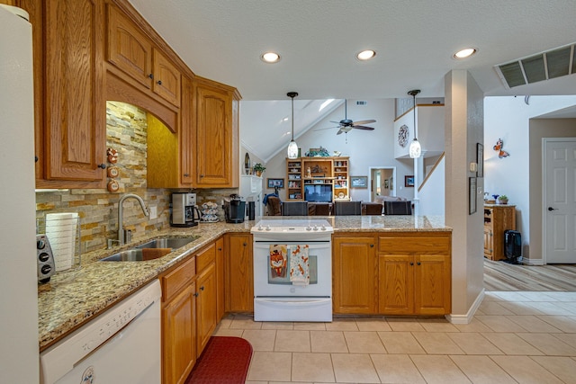 kitchen featuring sink, decorative backsplash, hanging light fixtures, kitchen peninsula, and white appliances