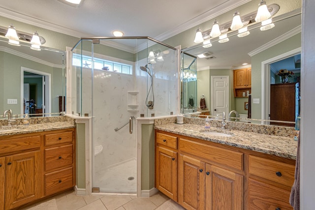 bathroom featuring ornamental molding, vanity, a shower with shower door, and tile patterned floors