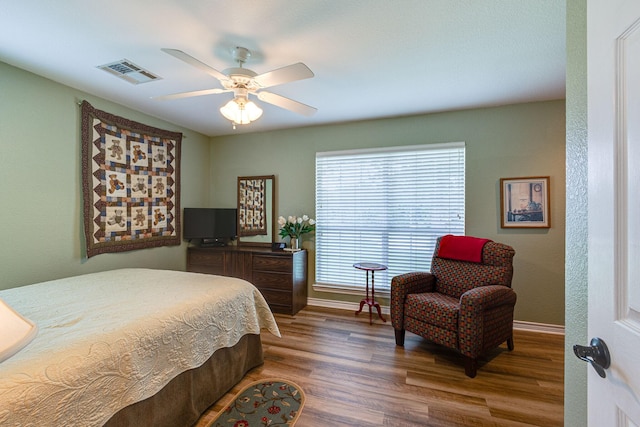 bedroom with dark wood-type flooring and ceiling fan