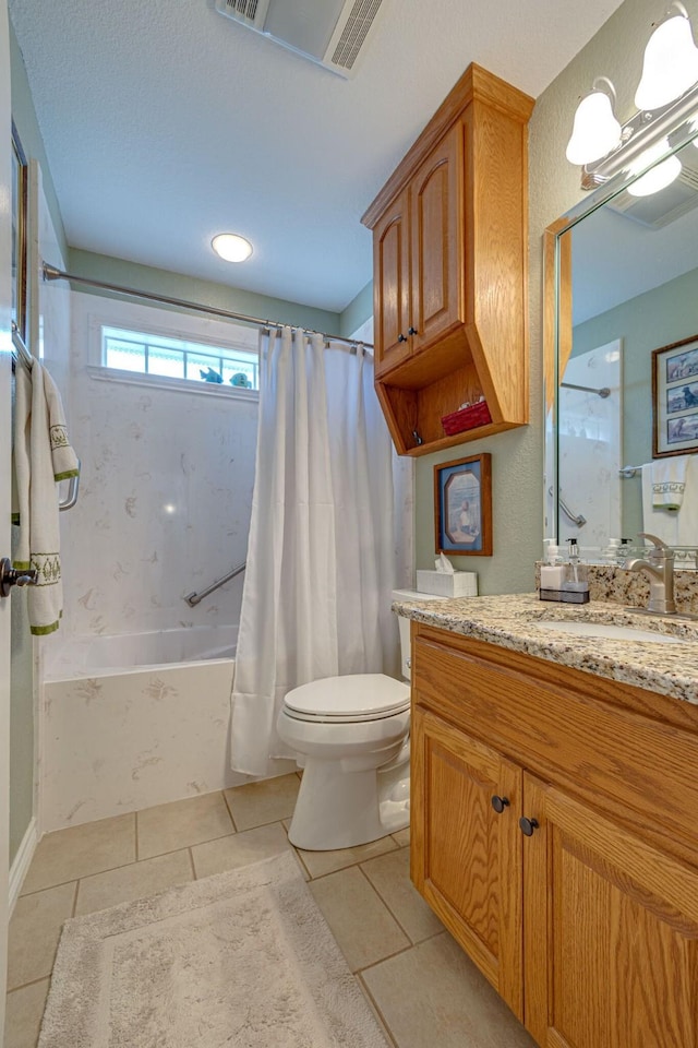 full bathroom featuring tile patterned flooring, vanity, shower / tub combo, and toilet