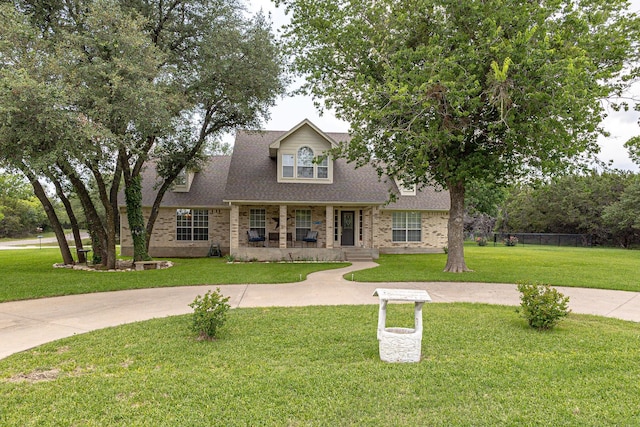 view of front of house featuring covered porch and a front lawn