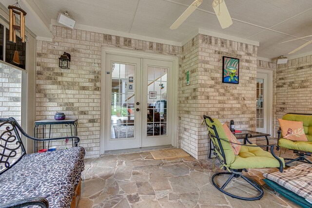 entrance to property featuring french doors, ceiling fan, and a patio