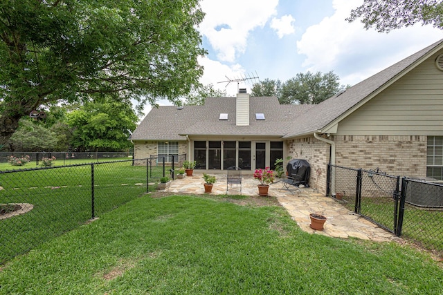 exterior space featuring a yard, a patio area, and a sunroom