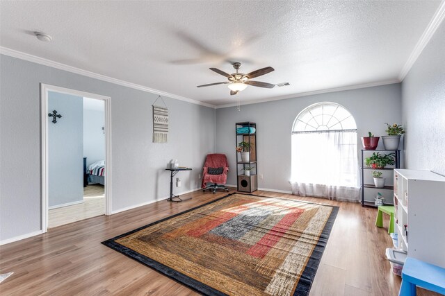 interior space featuring crown molding, ceiling fan, and wood-type flooring