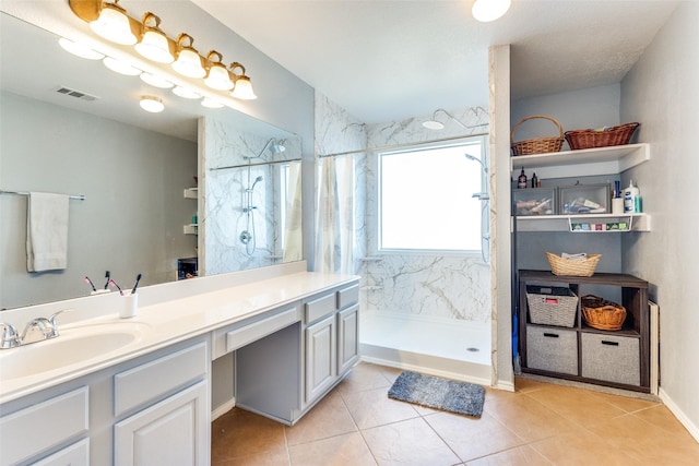 bathroom featuring a shower with shower curtain, vanity, and tile patterned floors