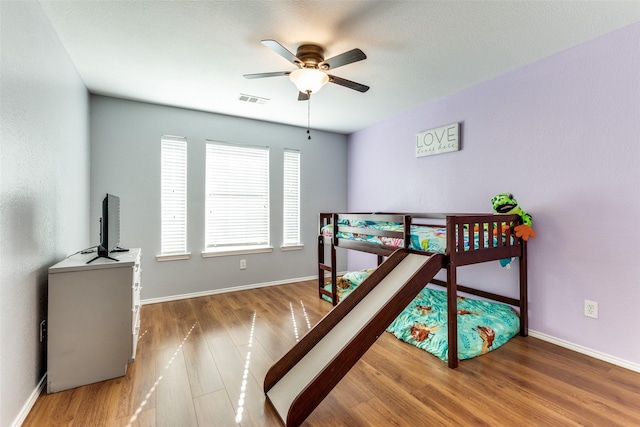 bedroom with wood-type flooring and ceiling fan