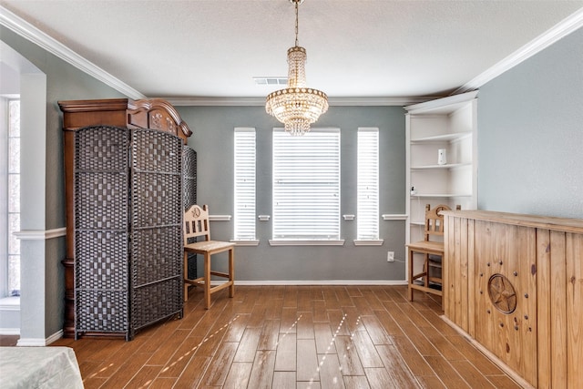 miscellaneous room featuring dark hardwood / wood-style flooring, ornamental molding, and a chandelier