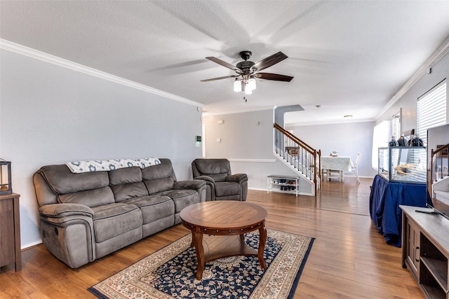 living room with ceiling fan, hardwood / wood-style floors, and ornamental molding