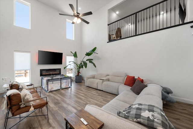 living room featuring ceiling fan and hardwood / wood-style floors