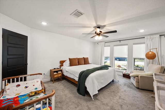 bedroom with recessed lighting, visible vents, light carpet, ceiling fan, and a textured ceiling