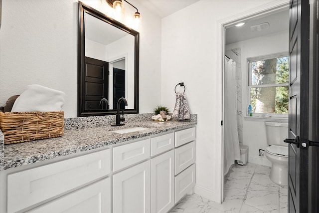 bathroom with marble finish floor, toilet, vanity, and baseboards