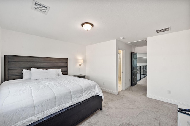 bedroom featuring baseboards, light colored carpet, visible vents, and attic access