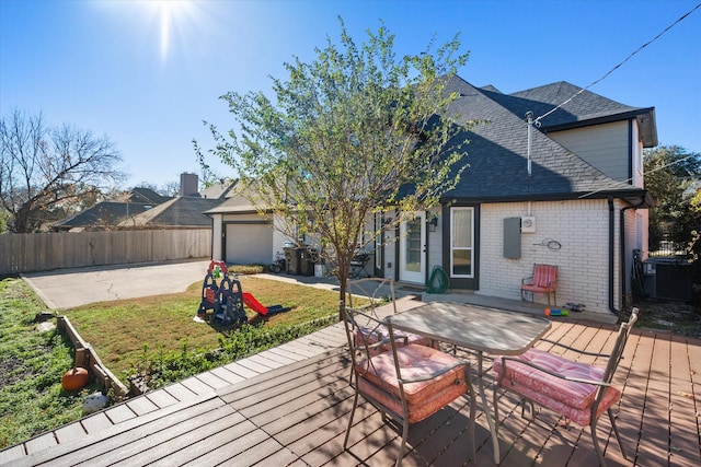 wooden terrace with a yard and a garage