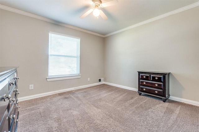 carpeted spare room featuring ceiling fan and ornamental molding