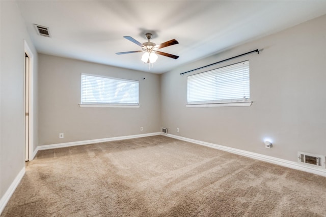 carpeted spare room with ceiling fan