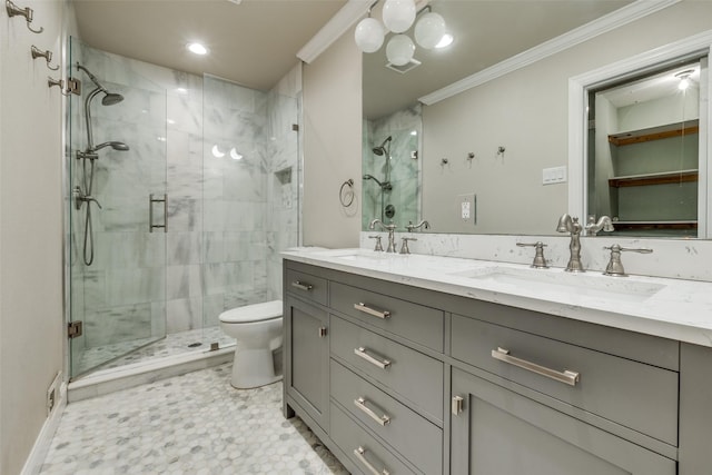 bathroom featuring crown molding, a shower with door, vanity, and toilet