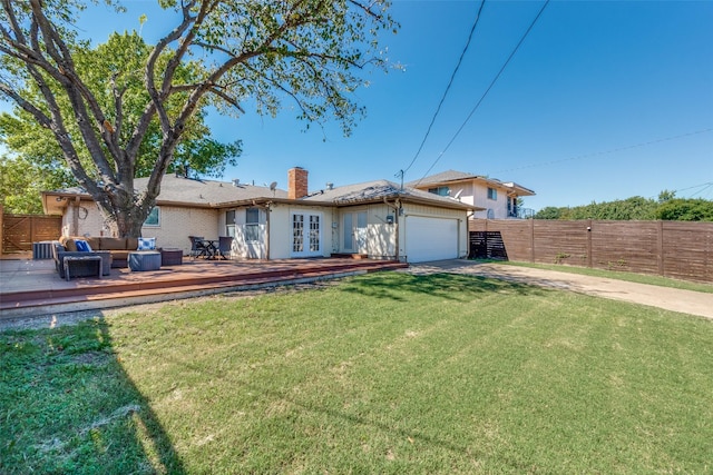 back of property featuring outdoor lounge area, a yard, french doors, and a deck