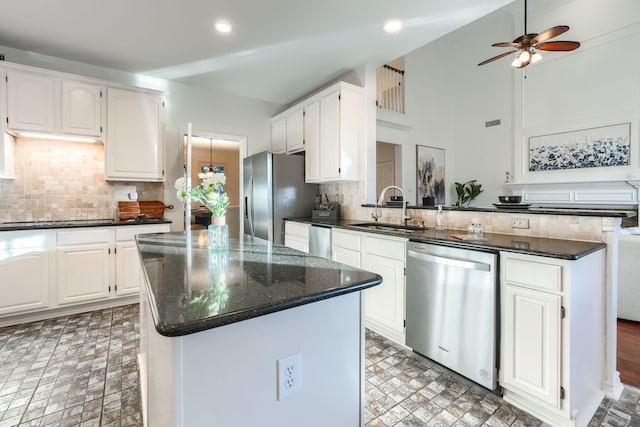 kitchen with sink, a center island, white cabinets, and appliances with stainless steel finishes