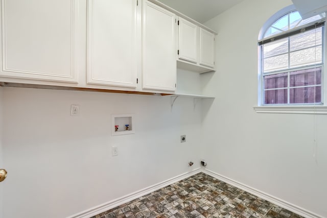 washroom featuring hookup for an electric dryer, hookup for a washing machine, and cabinets