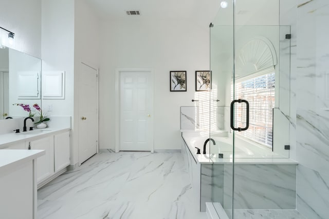 bathroom featuring vanity and independent shower and bath