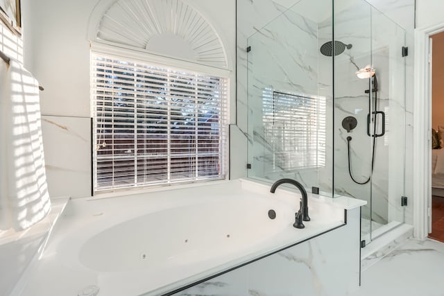 bathroom featuring separate shower and tub