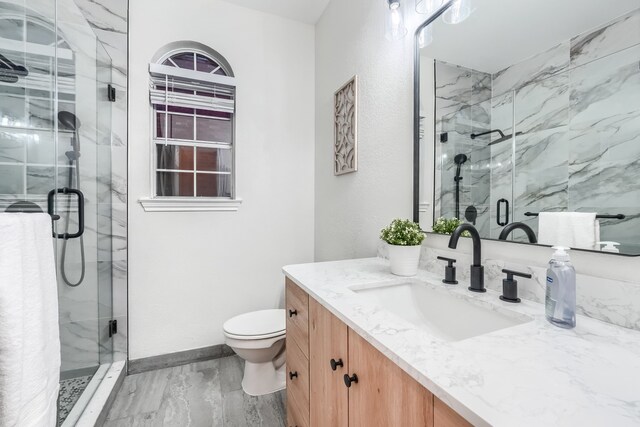 bathroom with vanity, toilet, and walk in shower