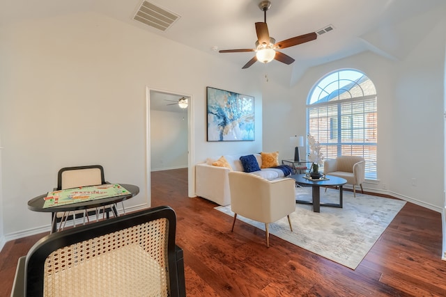 living room featuring dark hardwood / wood-style flooring, vaulted ceiling, and ceiling fan