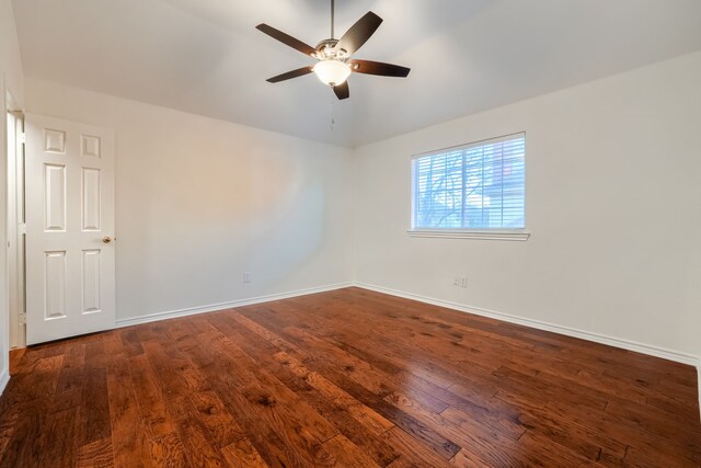 spare room with vaulted ceiling, ceiling fan, and dark wood-type flooring