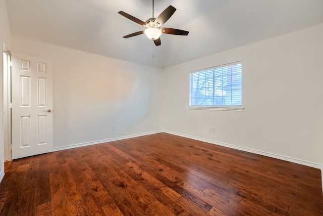 spare room with dark hardwood / wood-style flooring and ceiling fan