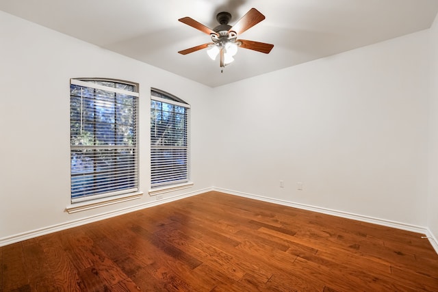 spare room with hardwood / wood-style flooring and ceiling fan