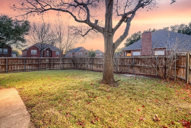 view of yard at dusk