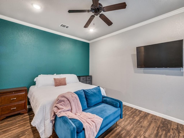 bedroom featuring ceiling fan, dark hardwood / wood-style flooring, and crown molding